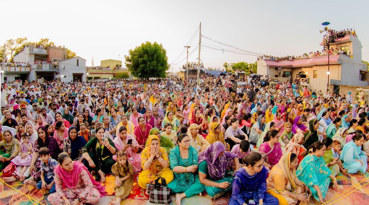 Women gather at a public programme in Punjab ahead of the launch of the state's financial aid scheme for eligible women beneficiaries.