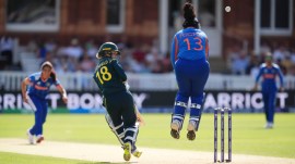 Australia's Phoebe Litchfield and India's wicketkeeper Richa Ghosh in action during the Women's T20 World Cup cricket match between Bangladesh and South Africa at Lord's Cricket Ground, in London, Sunday June 28, 2026. (Adam Davy/PA via AP)