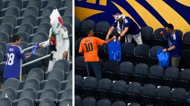 Japan fans clean up trash in the stadium following the FIFA World Cup Group F match against Netherlands. (AP)
