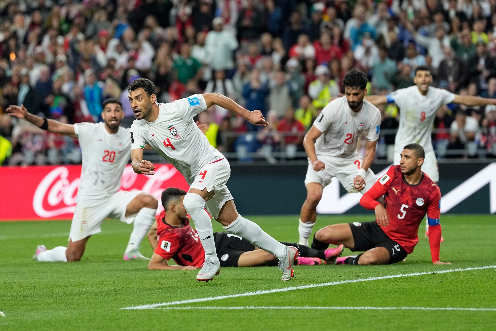 Iran's Shoja Khalilzadeh (4) celebrates after scoring a goal before it was overturned following a VAR review during the World Cup Group G soccer match between Egypt and Iran in Seattle, Friday, June 26, 2026. (AP Photo/Lindsey Wasson)