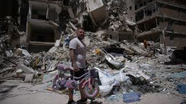 War: Barber Wissam Srour, 41, holds his daughter's bicycle recovered from his barbershop as he searches for belongings in the rubble of the shop, damaged in an Israeli strike, in the southern port city of Tyre, Lebanon. (AP Photo)