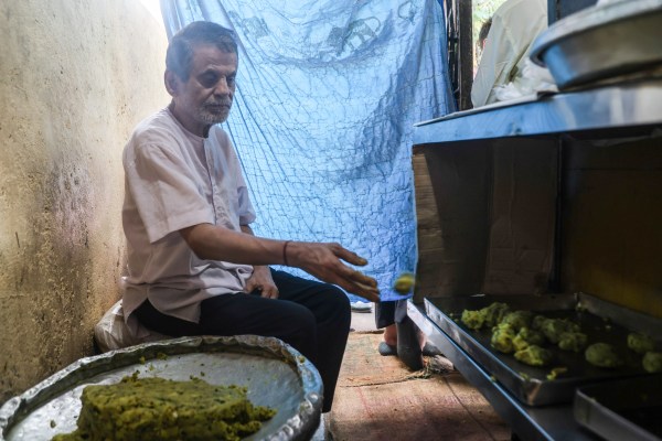 Manohar Thakur, who is speech impaired, quietly working the potato vada. Express photo by Akash Patil
