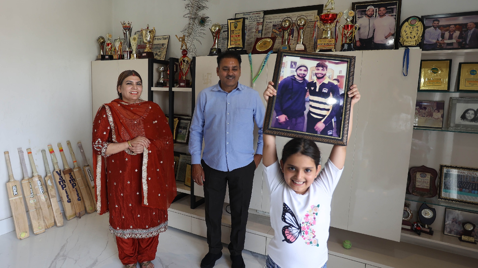 Nikhil's niece Jiya with his parents Sneh Kumar Chaudhary and Manju Chaudhary at Nikhil's room in Ludhiana. (Express Photo by Gurmeet Singh