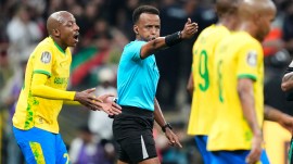 Somali referee Omar Artan, center, signals a penalty during the CAF Champions League final soccer match between AS FAR Rabat and Mamelodi Sundowns, in Rabat, Morocco, Sunday, May 24, 2026. (AP Photo/Mosa'ab Elshamy, File)
