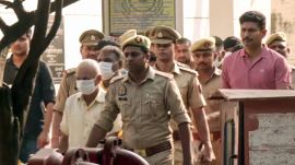 Ram Mandir donations alleged embezzlement case, following the court hearing, the eight accused are being taken away from the special court, in Ayodhya on Friday. (ANI Video Grab)