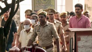 Ram Mandir donations alleged embezzlement case, following the court hearing, the eight accused are being taken away from the special court, in Ayodhya on Friday. (ANI Video Grab)