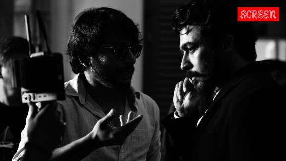 Actor Suriya with director RJ Balaji on the sets of Karuppu