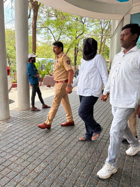 ThynkTech India CEO Harshal Thakre being escorted by police after being detained in Nashik. (Special arrangement)