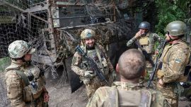 Ukrainian soldiers gather at a frontline position as Ukraine intensifies long-range strikes on Russian military infrastructure, including the Dubna Satellite Communications Centre. (Source: Reuters)