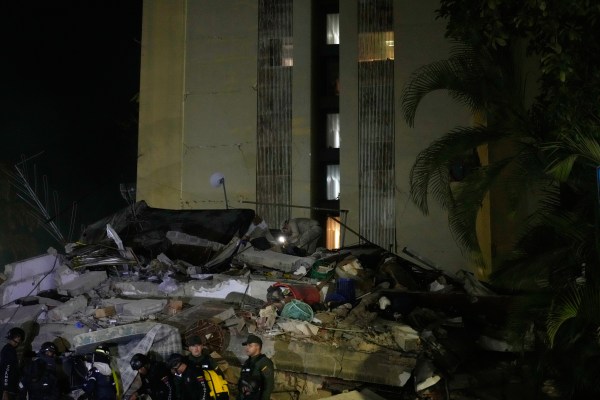 Rescue workers search through the rubble of a collapsed building for survivors after an earthquake in Caracas, Venezuela, Wednesday, June 24, 2026. (AP Photo/Ariana Cubillos)