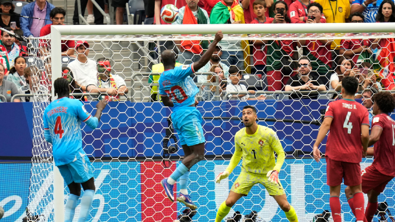 Congo's Yoane Wissa (20) scores his side's first goal against Portugal goalkeeper Diogo Costa during the World Cup Group K soccer match between Portugal and Congo in Houston, Wednesday, June 17, 2026. (AP Photo/Karen Warren)