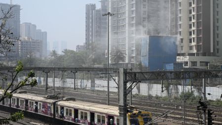 Dust billows out of a construction site of a building situated beside the Western Railway tracks, at Borivali in Mumbai, contributing towards the air pollution. Express photo by Sankhadeep Banerjee 8.3.2026