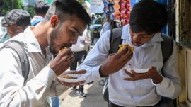 People enjoying hot vada pavs outside Ashok Vada Pav. Express photo by Akash Patil