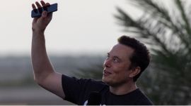 Elon Musk raises his phone towards the sky at the SpaceX Starbase, in Brownsville, Texas, US. (REUTERS)