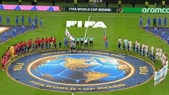 When the time came for the national anthems to be played, the full squads of both teams, including the substitutes, stood around the centre circle facing each other (AP Photo)