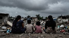 Garib Nagar families stare at a monsoon amid rubble