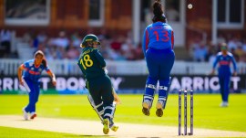 Australia's Phoebe Litchfield and India's wicketkeeper Richa Ghosh in action during the Women's T20 World Cup cricket match between Bangladesh and South Africa at Lord's Cricket Ground. (PA via AP)