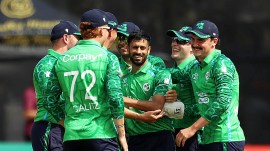 Ireland's Jai Moondra, center, celebrates with team-mates after bowling out India's Sanju Samson during the first T20I test match at Stormont, Belfast, Northern Ireland, Friday June 26, 2026. (Liam McBurney/PA via AP)