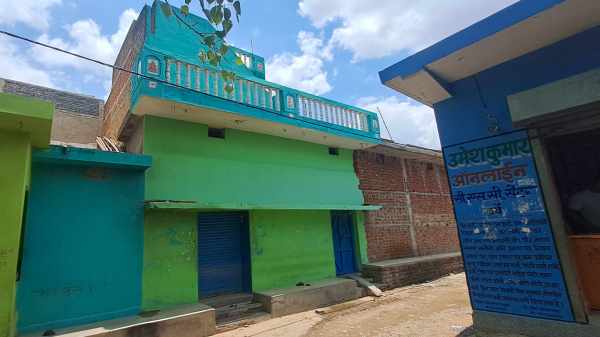 House of Ramsahay Jaiswal. The one storied structure in green and two blue shutters.