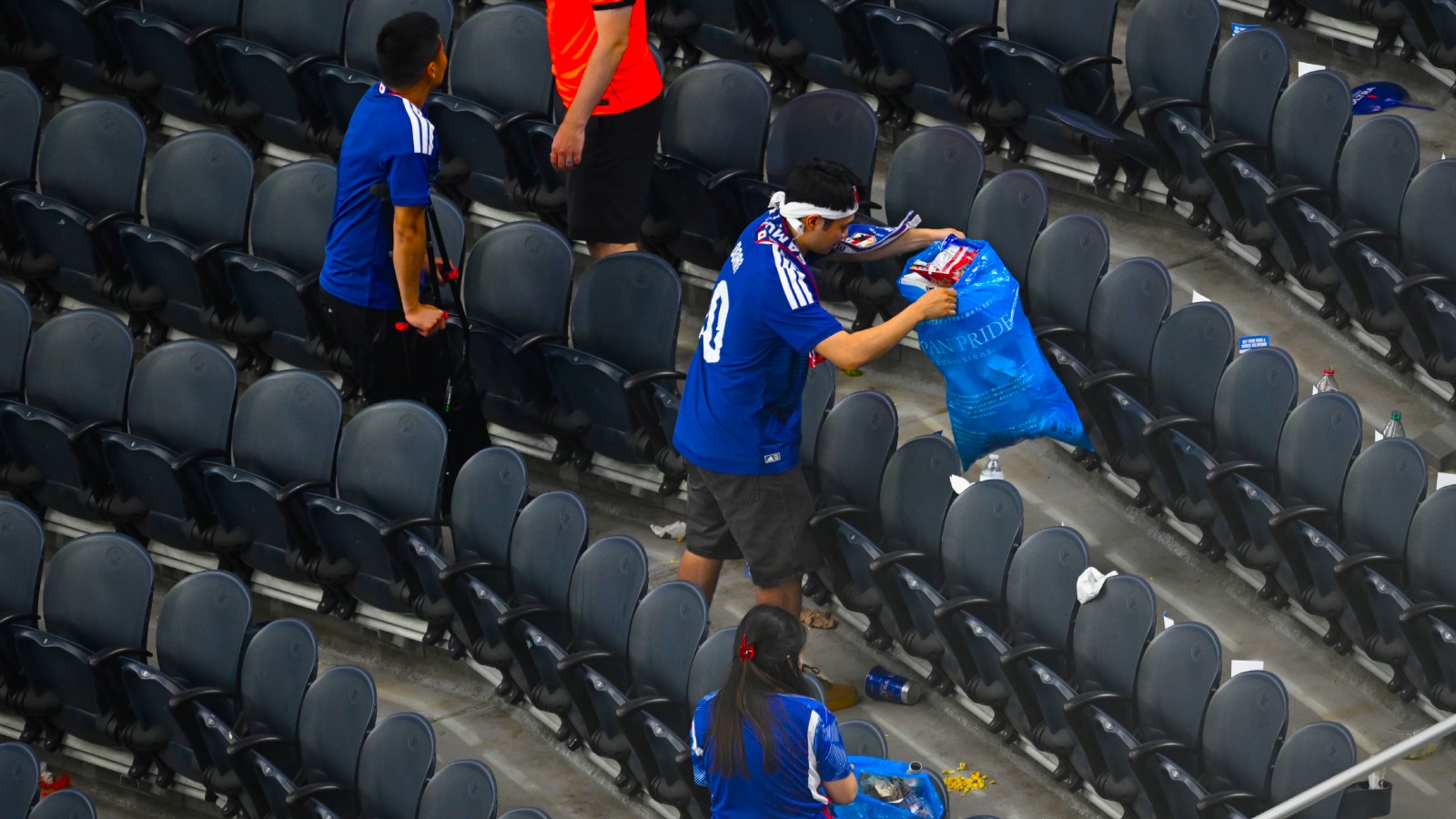 Japan fans clean up trash in the stadium following the World Cup Group F soccer match between the Netherlands and Japan in Arlington, Texas, near Dallas, Sunday, June 14, 2026. (AP Photo)