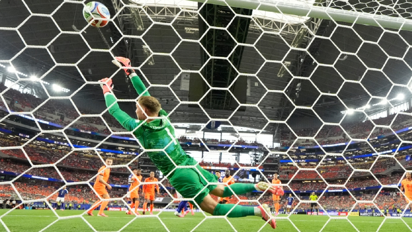 Netherlands goalkeeper Bart Verbruggen (1) is beaten by a header from Japan's Daichi Kamada (15) for their second goal during the World Cup Group F soccer match between the Netherlands and Japan in Arlington, Texas, near Dallas, Sunday, June 14, 2026. (AP Photo)