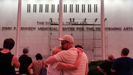 A couple kiss in front of the John F. Kennedy Center for the Performing Arts, Friday, June 12, 2026, in Washington. (AP Photo)