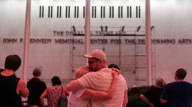 A couple kiss in front of the John F. Kennedy Center for the Performing Arts, Friday, June 12, 2026, in Washington. (AP Photo)