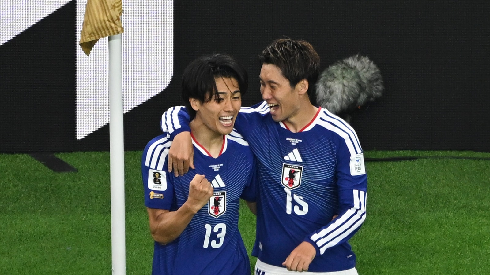 Keito Nakamura (left) celebrates after scoring Japan's opening goal with teammate Daichi Kamada during the World Cup Group F match against the Netherlands. (AP Photo/Jessica Tobias)