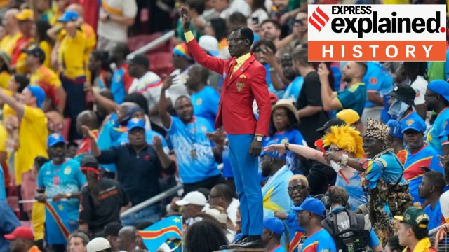 Congo supporter Michel Nkuka Mboladinga, poses as a statue of the country's assassinated independence hero Patrice Lumumba ahead of the World Cup Group K soccer match between Colombia and Congo (AP Photo)