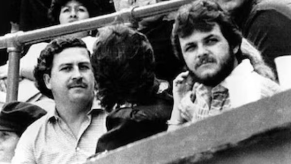 Pablo Escobar, left, watches a football game in Medellin, Colombia in 1983. (AP)