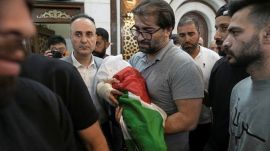 Fahd Abu Haikal, 41 carries the body of his seven month old Palestinian baby boy Sam, who was killed on Friday when, according to the Palestinian health ministry, Israeli soldiers fired at the vehicle carrying him and his parents in Tel Rumeida, during his funeral in the West Bank city of Hebron, Saturday, June 6, 2026. (AP Photo/Mahmoud Illean)