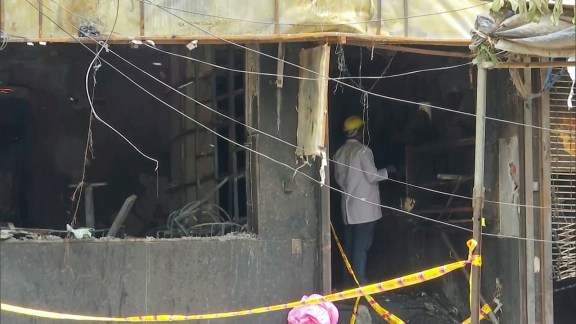 Forensic teams at the site where a catastrophic fire broke out, reportedly claiming 21 lives
