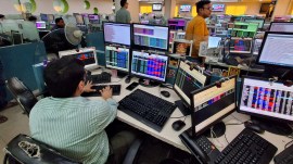 Employees of a share-broking firm track the impact on the stock market at their office.