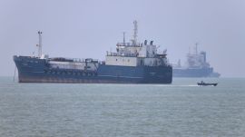 A small motorboat passes anchored vessels in the Strait of Hormuz off Bandar Abbas, Iran, Wednesday, June 17, 2026.(Amirhosein Khorgooi/ISNA via AP)