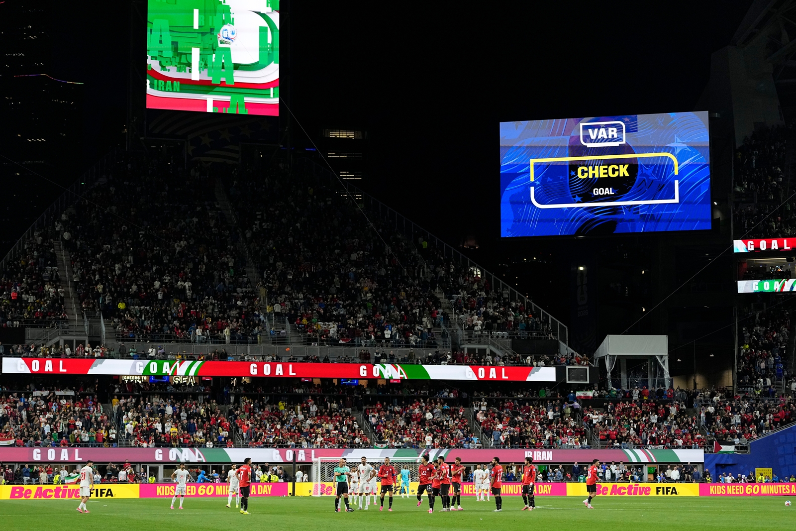 Players of the two teams await a VAR review after Khalilzadeh's goal that was later overturned during the World Cup Group G soccer match between Egypt and Iran in Seattle. (AP Photo/Lindsey Wasson)