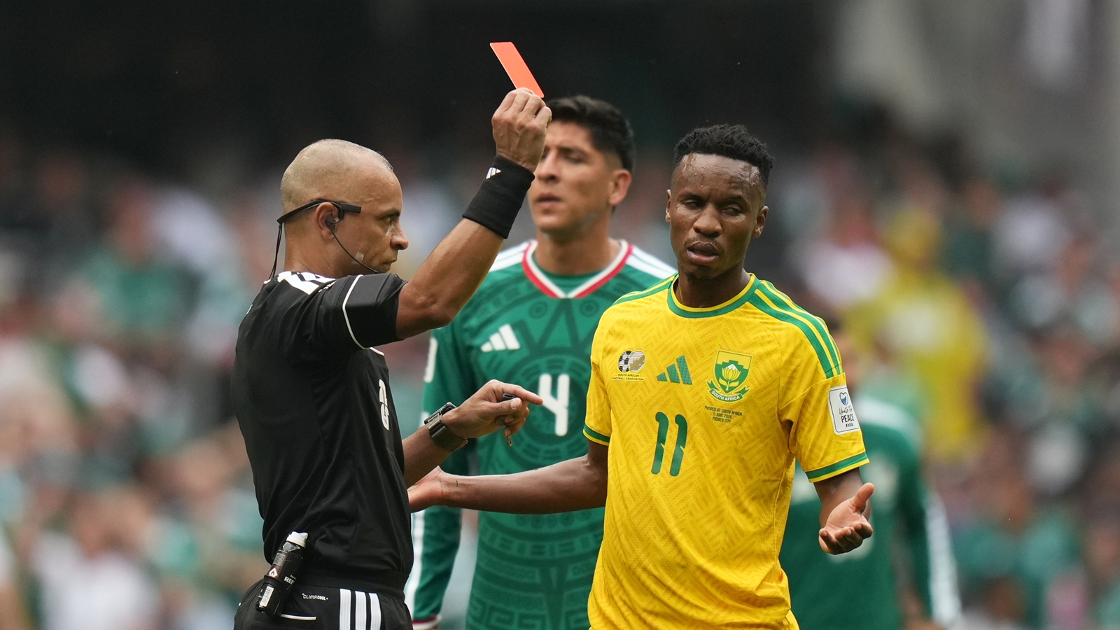 Referee Wilton Sampaio, of Brazil, show the red card to South Africa's Themba Zwane. (AP Photo)