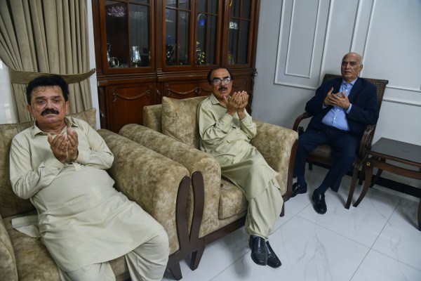 Ghulam Nabi Bahrani, left, father-in-law of missing cargo plane crew First Officer Faisal Jatoi, with others pray for Jatoi at his home in Karachi, Pakistan, Wednesday. (AP Photo)
