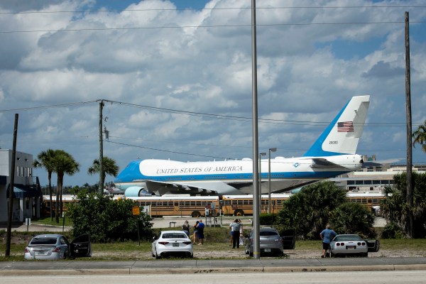 People take photos in front of Air Force One, parked at Palm Beach International Airport, in West Palm Beach, Florida, April 20, 2019. (REUTERS)