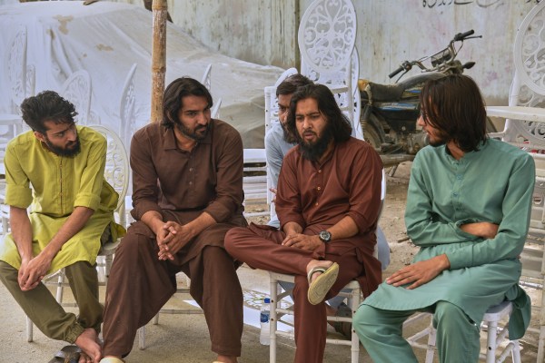 Abdur Rafay Siddiqui, second right, elder son of missing cargo plane crew flight engineer Muhammad Arif Siddiqui, chats with siblings outside their home in Karachi. (AP Photo)