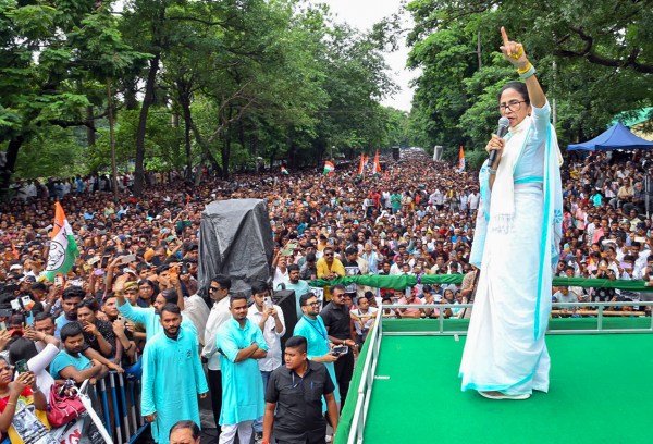 West Bengal former Chief Minister Mamata Banerjee addresses the gathering near Birla Planetarium as a sea of people assembled to observe 'Shahid Diwas' and pay tribute to the martyrs of 1993, in Kolkata on Tuesday. (@AITCofficial X/ANI Photo)