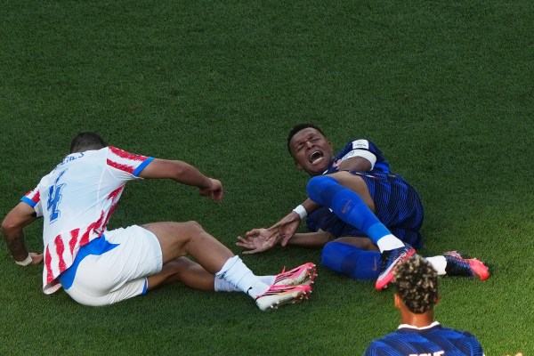Mbappe grimaces in pain during the World Cup round of 16 soccer match against Paraguay. (AP Photo/Matt Rourke)