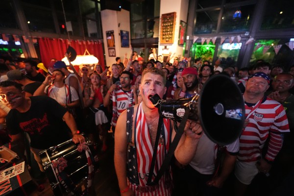 US football fans with the American Outlaws supporters group in a chant during a live broadcast of the World Cup round of 16 match between the United States and Belgium at The Leinster Irish pub in Miami. (AP Photo/Rebecca Blackwell)