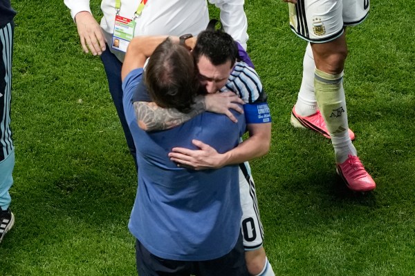 Argentina head coach Lionel Scaloni hugs Lionel Messi after the World Cup round of 16 soccer match against Egypt in Atlanta. (AP Photo/Chris Carlson)