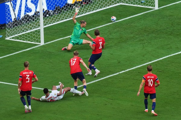 Bellingham scores against Norway goalkeeper Oerjan Nyland (1) as Kristoffer Ajer (3), Torbjoern Heggem (17), Sander Berge (8) and Martin Oedegaard (10) look on during the World Cup quarterfinal. (AP Photo/Marta Lavandier)