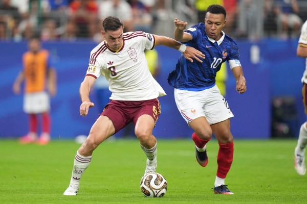 Fabian Ruiz and France's Kylian Mbappe battle for the ball during the World Cup semifinal. (AP Photo/Eric Gay)
