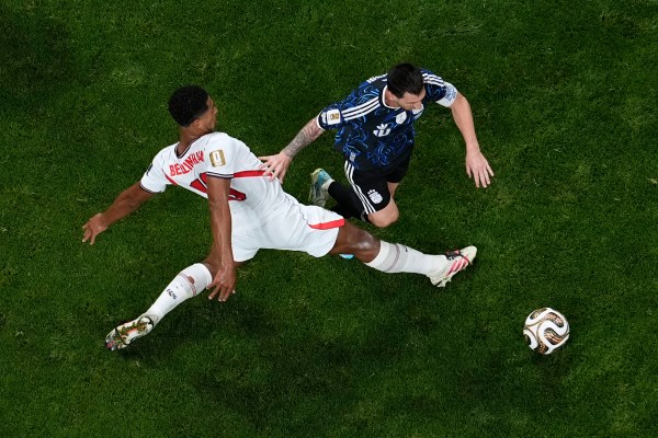 Bellingham, left, and Messi collide during the World Cup semifinal match between England and Argentina in Atlanta. (AP Photo/George Walker IV)