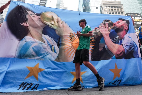 A fan arrives for Argentina's rally on the eve of the World Cup final match in New York's Times Square. (AP Photo/Frank Franklin II)