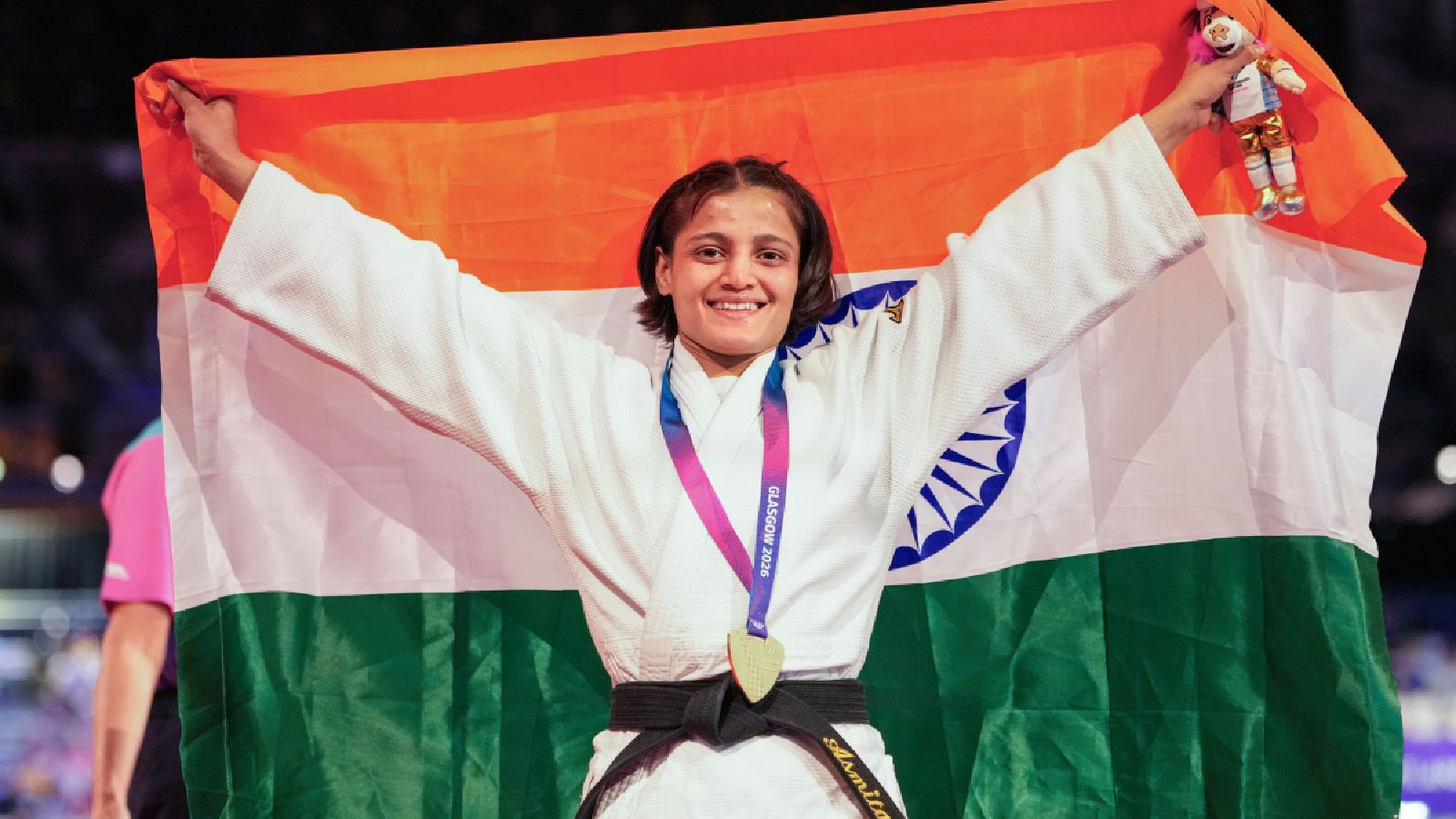 India's Asmita Dey celebrates with the national flag after winning the gold medal in the Women's 48kg judo event at the Commonwealth Games 2026, in Glasgow, Scotland, Friday, July 31, 2026. Asmita became the first Indian judoka to win a Commonwealth Games gold medal. (PTI Photo)