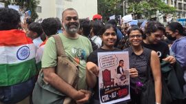 Rajesh Yadav at Shivaji Park on Friday with his daughter Annaysha, 19. "We are here for my daughter's future but also for a better education system for all," he said. (Express photo)