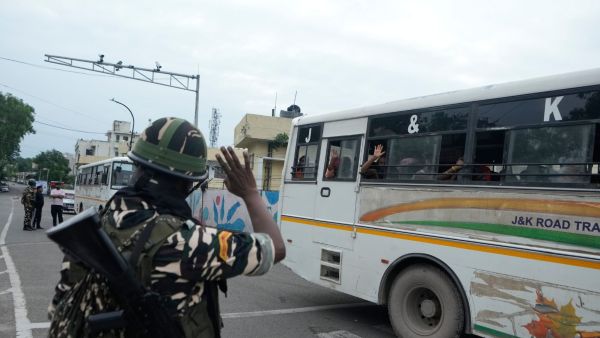 A paramilitary soldier waves to pilgrims as they leave for the annual Amarnath Yatra, the annual Hindu pilgrimage to the Amarnath cave shrine, from the base camp in Jammu, Thursday, July 2, 2026. (AP Photo)